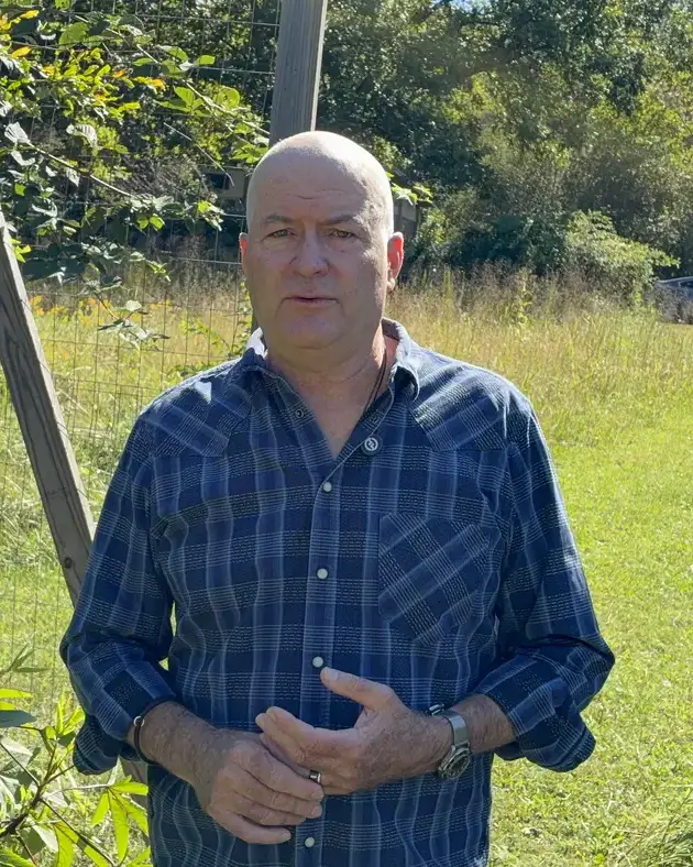 Dr. Maurice Werness at the gate of his farm garden